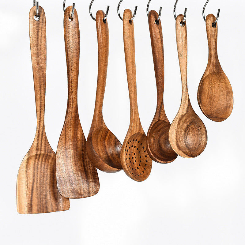 Chef using teak spoon to stir organic soup in pot