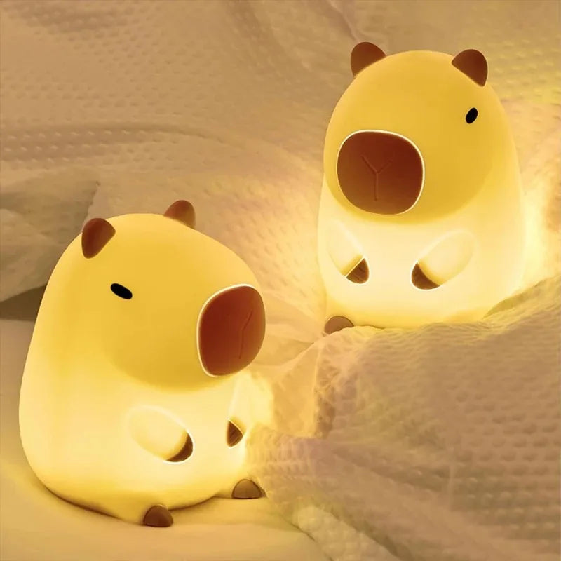 Brown capybara night light glowing on bedside table