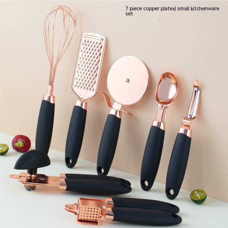 Garlic press crushing cloves with visible copper finish