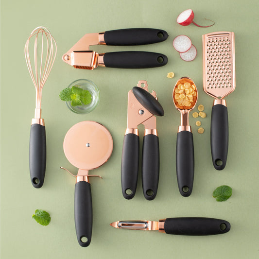 7-piece copper kitchen utensils arranged on marble counter