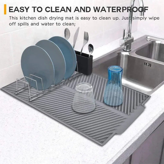 Gray sloped silicone draining mat under metal dish rack